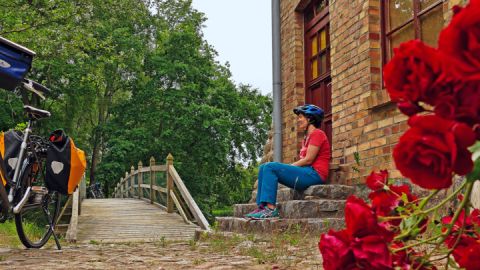 Radfahrerin am Gutshaus